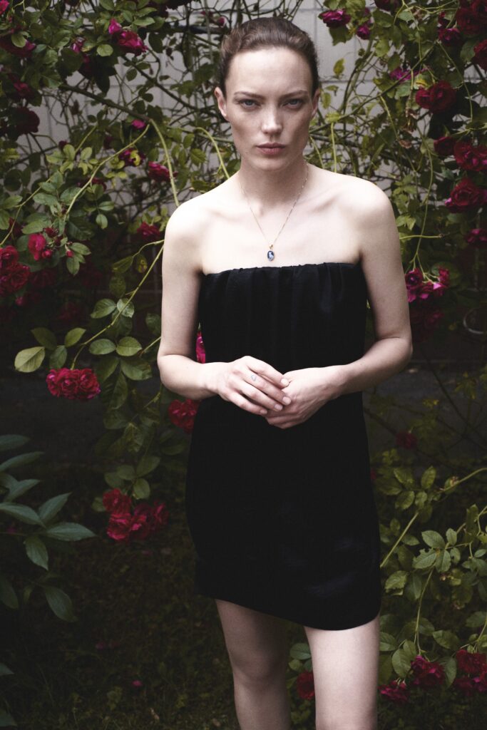 A fitted black silk strapless dress with a mini silhouette, perfect for elegant occasions.
