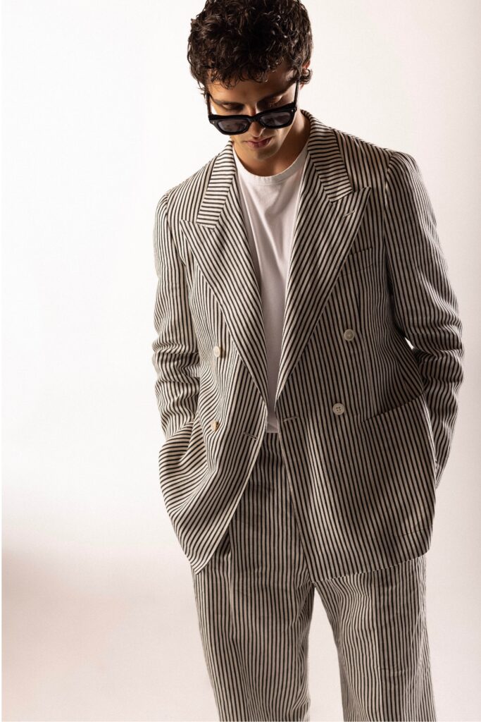 A tailored striped suit in black and white with a collared long-sleeve shirt.