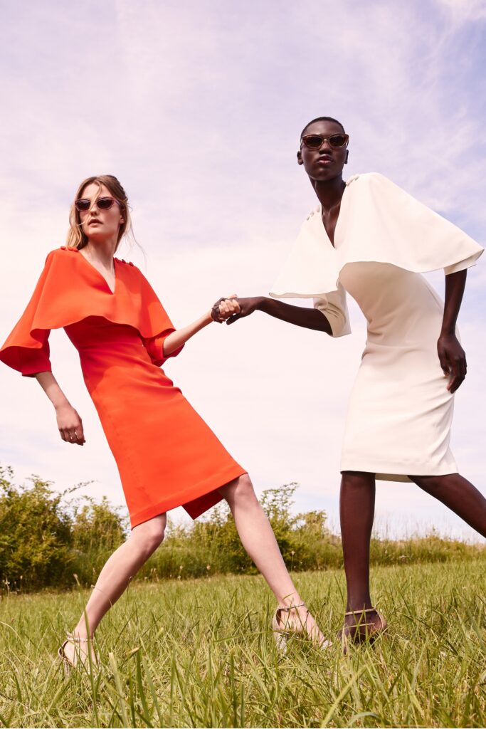 A fitted red and white dress with short sleeves and an asymmetric design.