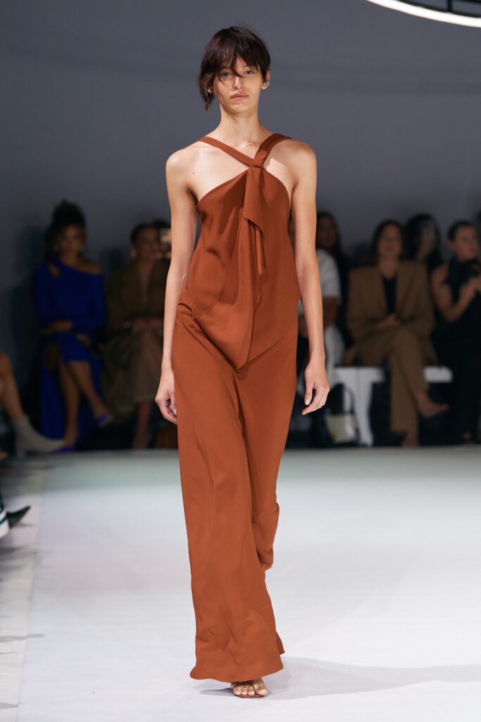 A relaxed brown silk sleeveless dress with a V-neckline and draped design.
