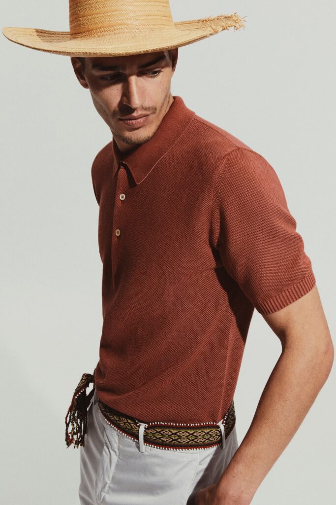 A fitted brown cotton shirt with short sleeves and a collared neckline, featuring a striped design.