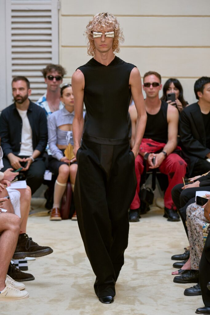 A fitted black sleeveless top paired with straight-leg pants, creating a sleek silhouette.