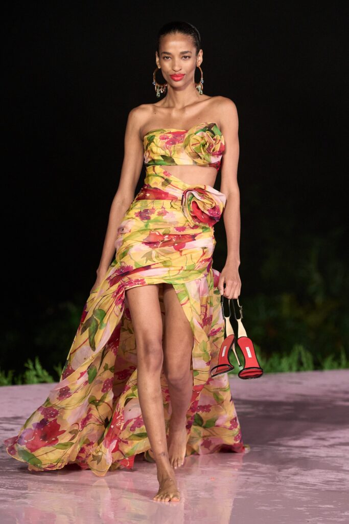 A fitted multicolor silk strapless dress with a flared asymmetric silhouette and tiered design.