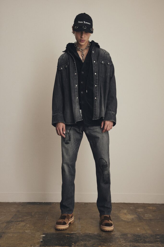 A relaxed black denim jacket with long sleeves paired with straight-leg gray denim pants.