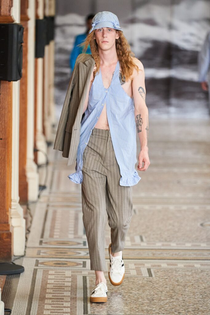 blue striped sleeveless top with gray pants