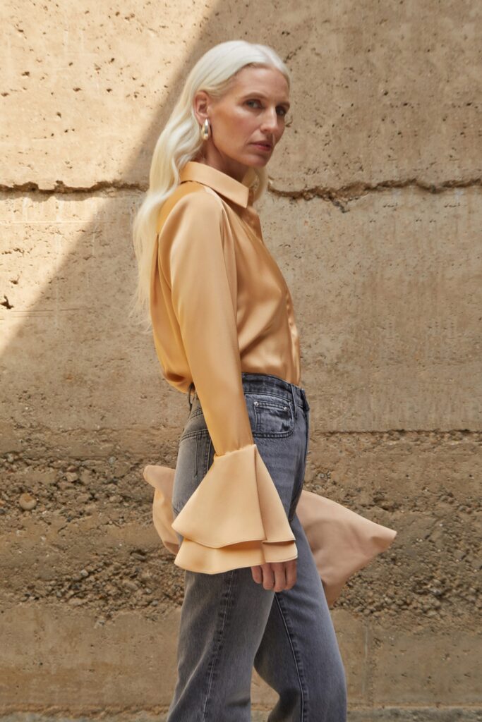 beige silk shirt and gray denim pants