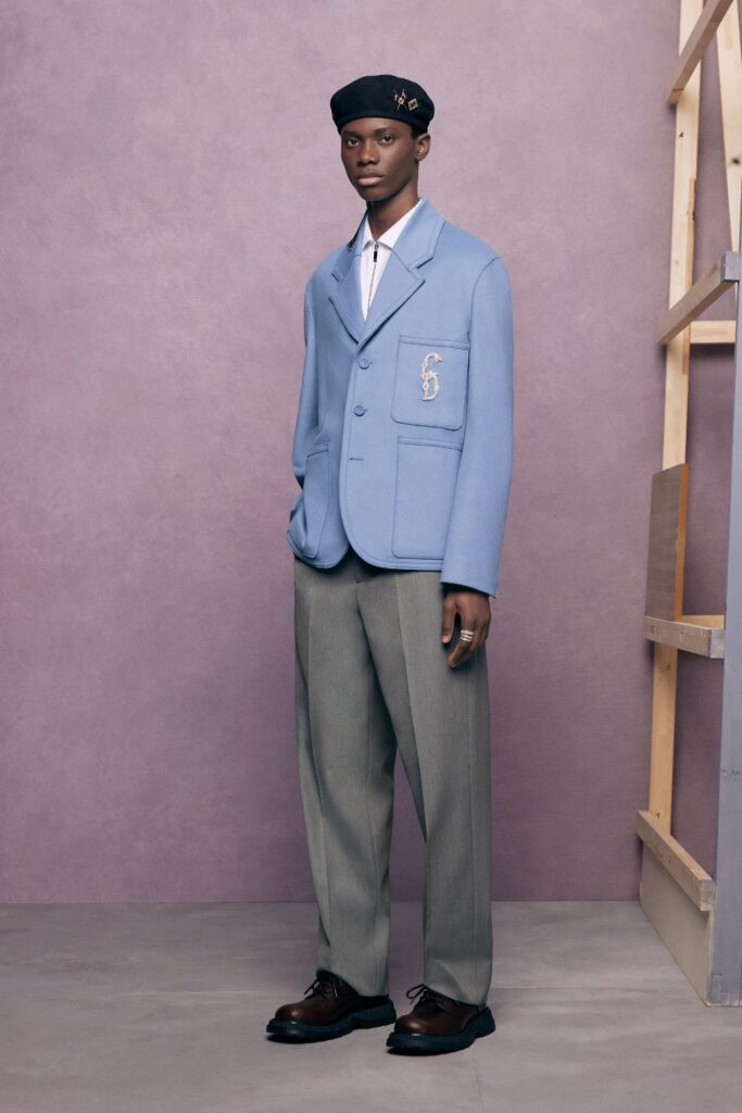 A tailored blue jacket paired with wide-leg gray pants for a sophisticated look.