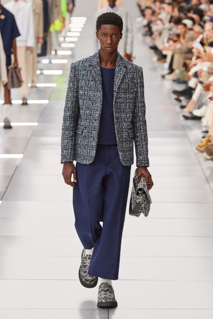 A relaxed fit blue tweed blazer paired with wide-leg pants for a stylish look.