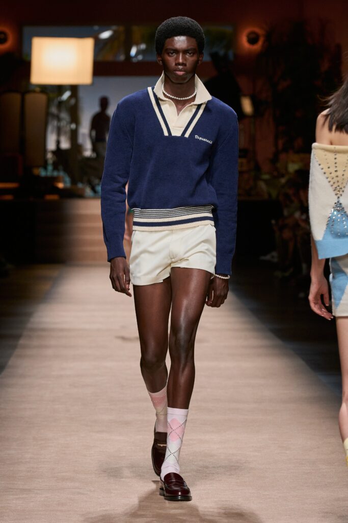 A fitted blue cotton long-sleeve collared sweater paired with white shorts featuring a striped design.