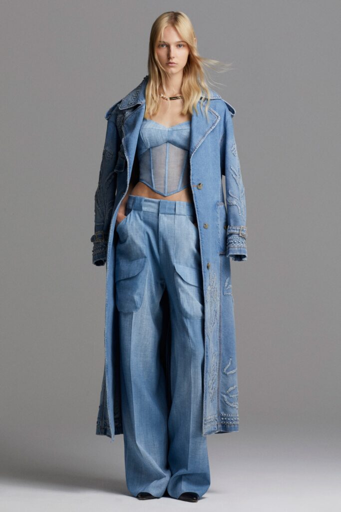 A relaxed blue denim coat layered over a sleeveless top with a collared design.