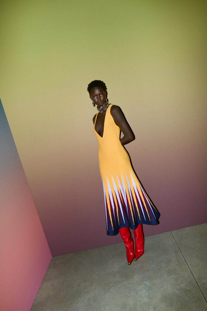 A fitted yellow sleeveless dress with a V-neckline and flared silhouette.