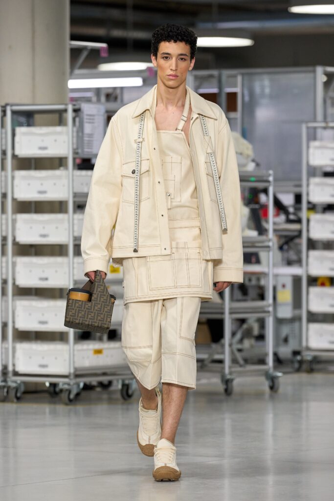A relaxed beige cotton jacket with a collared short-sleeve design paired with matching shorts.
