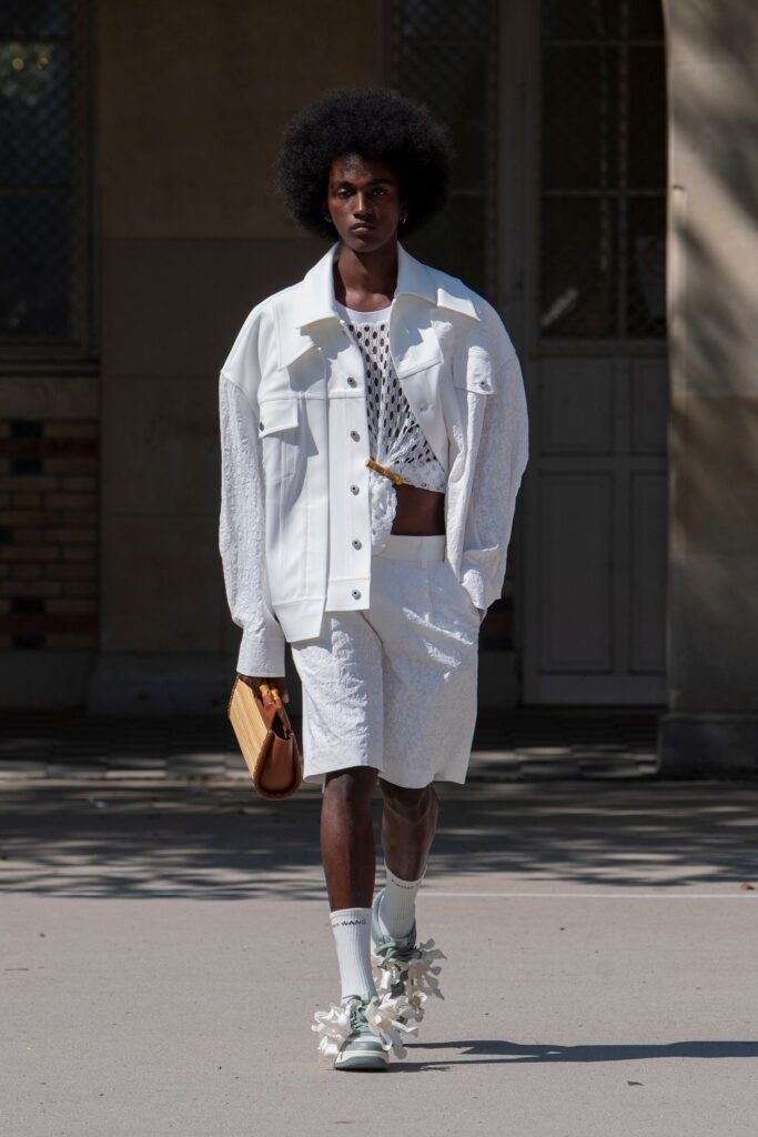 A relaxed white jacket paired with matching shorts, featuring a layered design.