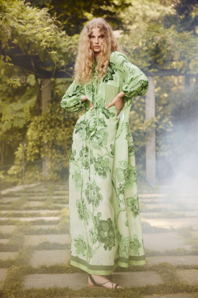 A relaxed green floral maxi dress with long sleeves and a collared neckline.