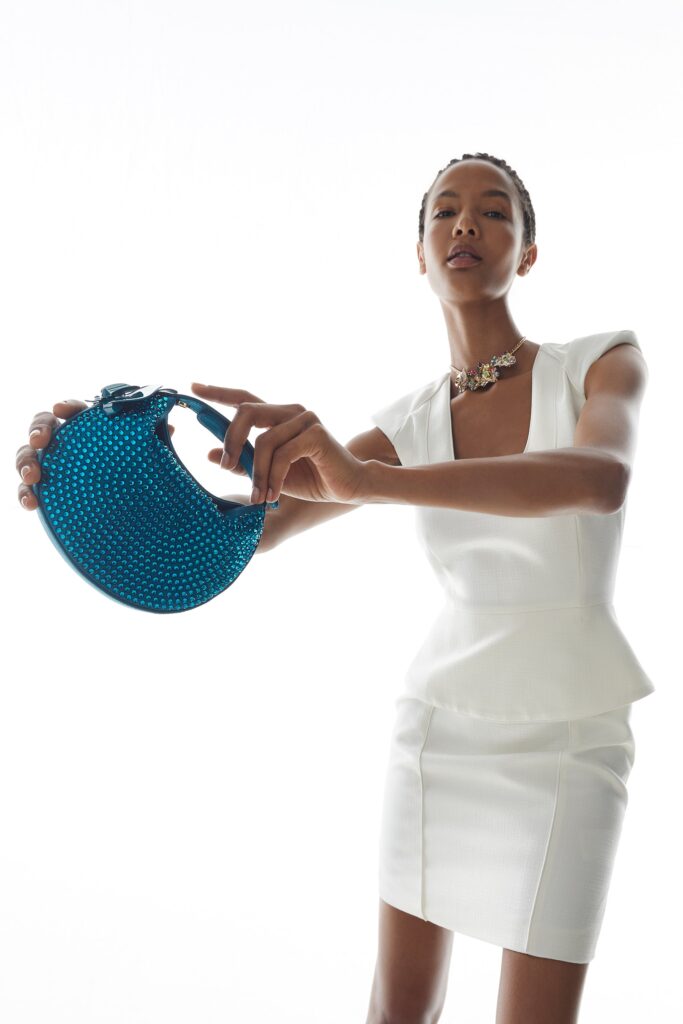 white fitted mini dress with blue bag