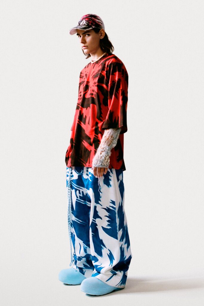 An oversized red printed top paired with blue printed pants, creating a bold streetwear look.