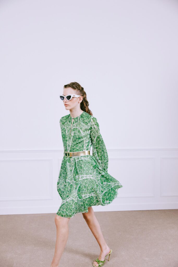 A relaxed green cotton long-sleeve dress with a flared silhouette and collared neckline.