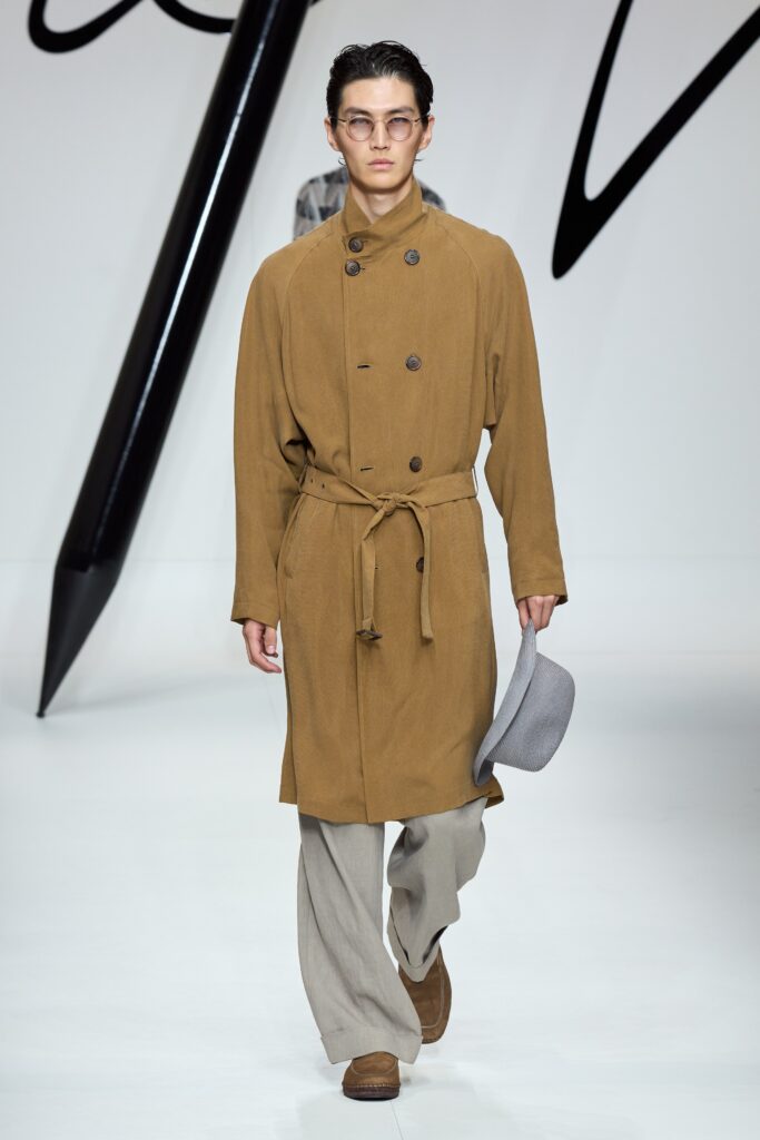 A relaxed brown wool coat with long sleeves, a collared neckline, and buttoned details.