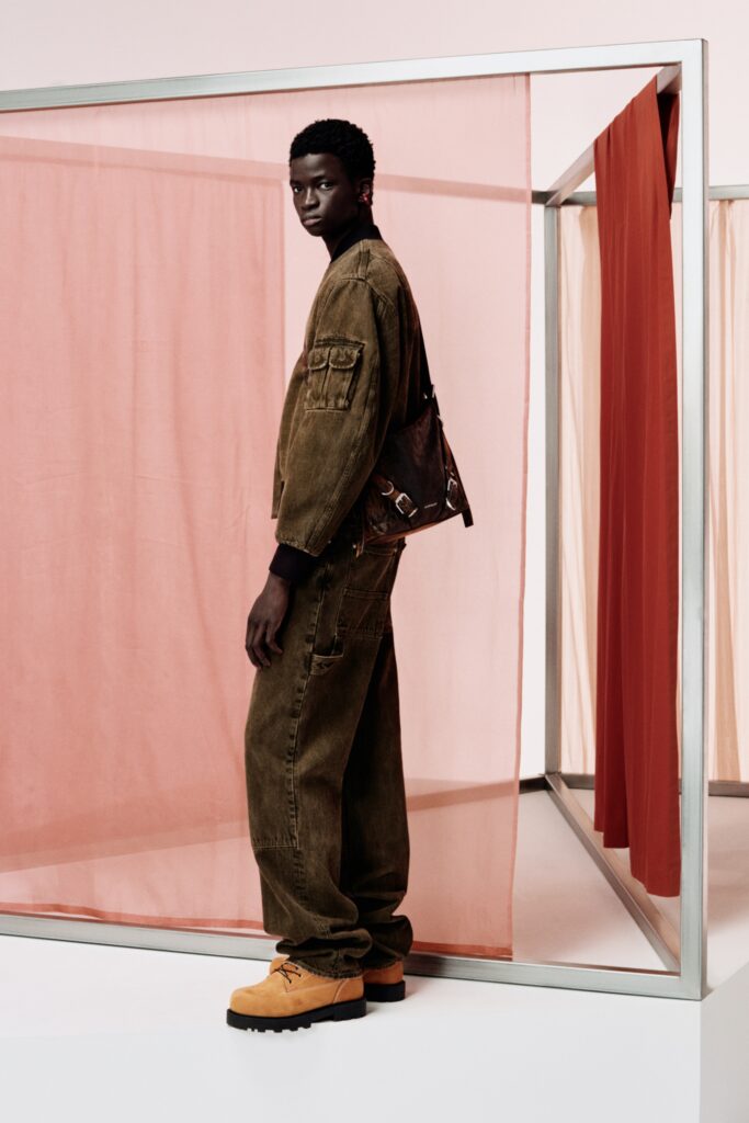 A relaxed brown denim jacket with long sleeves and collared design paired with wide-leg pants.