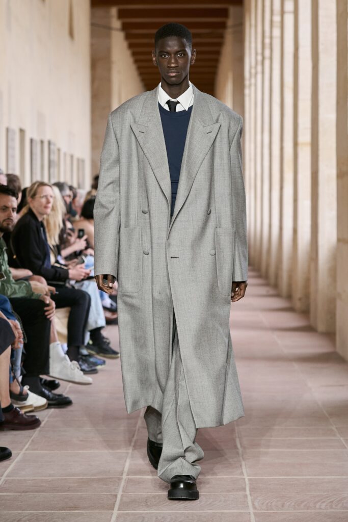 An oversized gray wool coat with long sleeves and a double-breasted design.