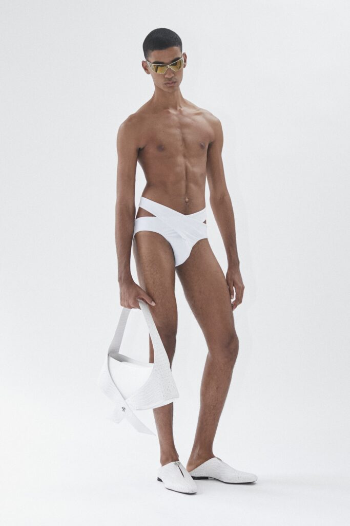 A fitted white swimsuit with cutout details and a sleeveless design.