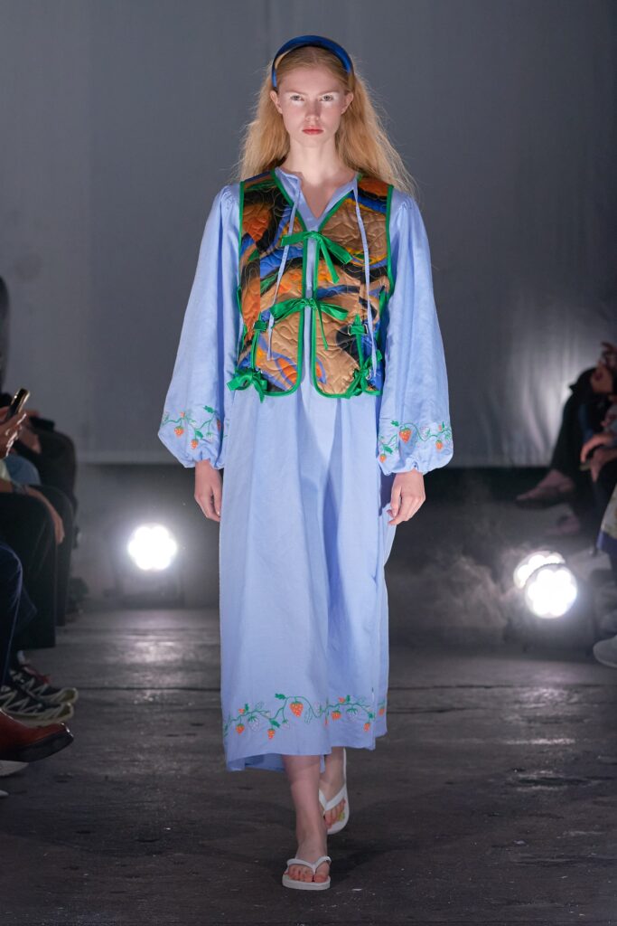 A relaxed blue cotton dress with long sleeves and embroidered details.