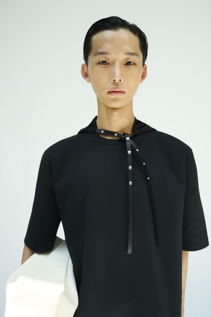 An oversized black cotton top with short sleeves and a unique neckline detail.