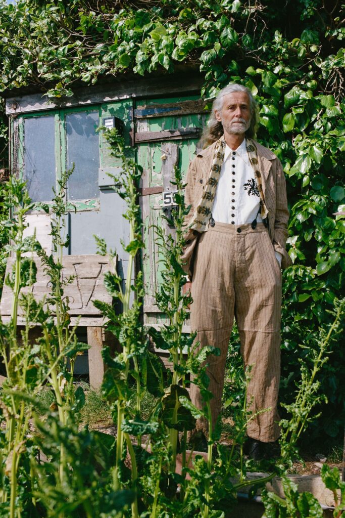 A relaxed beige striped suit with a long-sleeve collared shirt.