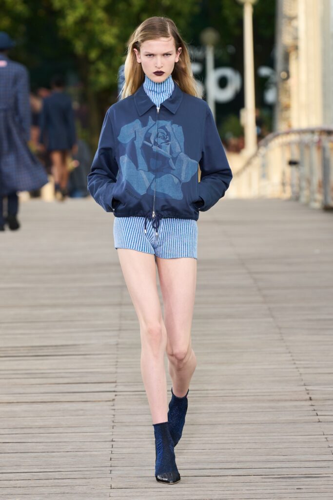 A fitted blue printed jacket paired with matching fitted shorts for a stylish look.