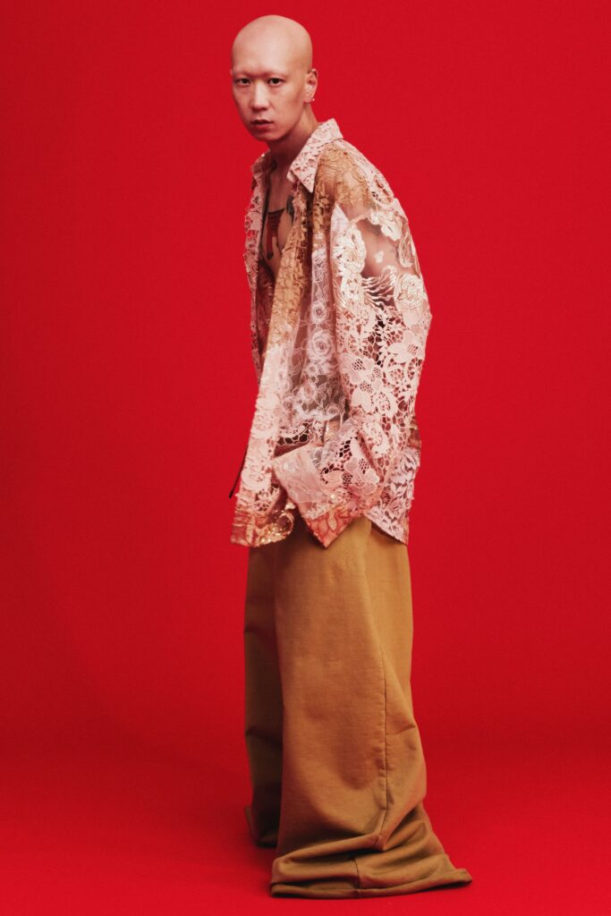 A relaxed beige lace shirt paired with green relaxed pants, creating a unique layered look.