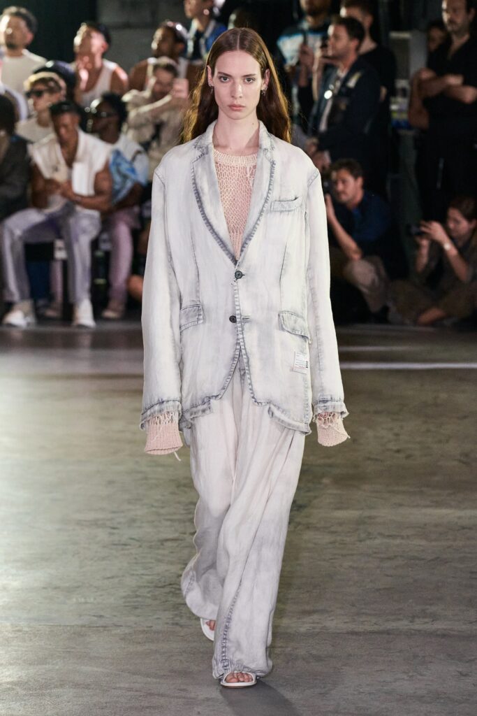 A relaxed gray denim jacket with long sleeves and collared design paired with matching pants.
