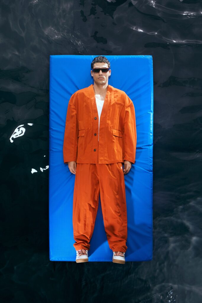 A relaxed-fit orange cotton jacket with long sleeves and matching pants, featuring a collared design.