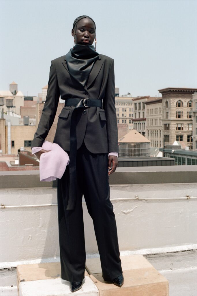 A tailored black blazer with long sleeves and wide-leg pants, creating a sophisticated look.
