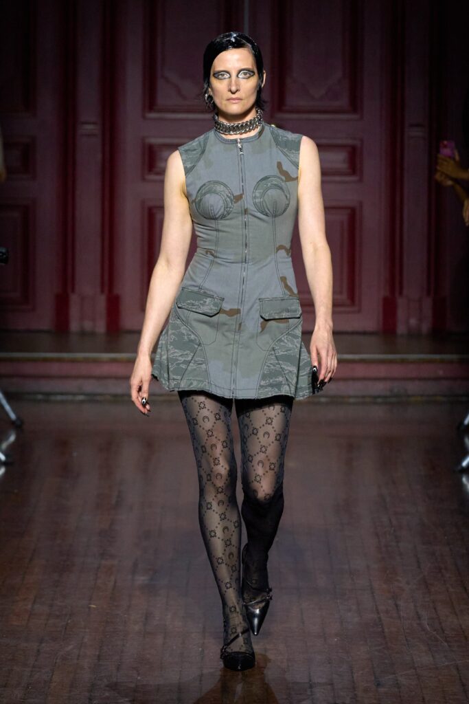 A fitted gray sleeveless dress with a collared neckline and structured design.