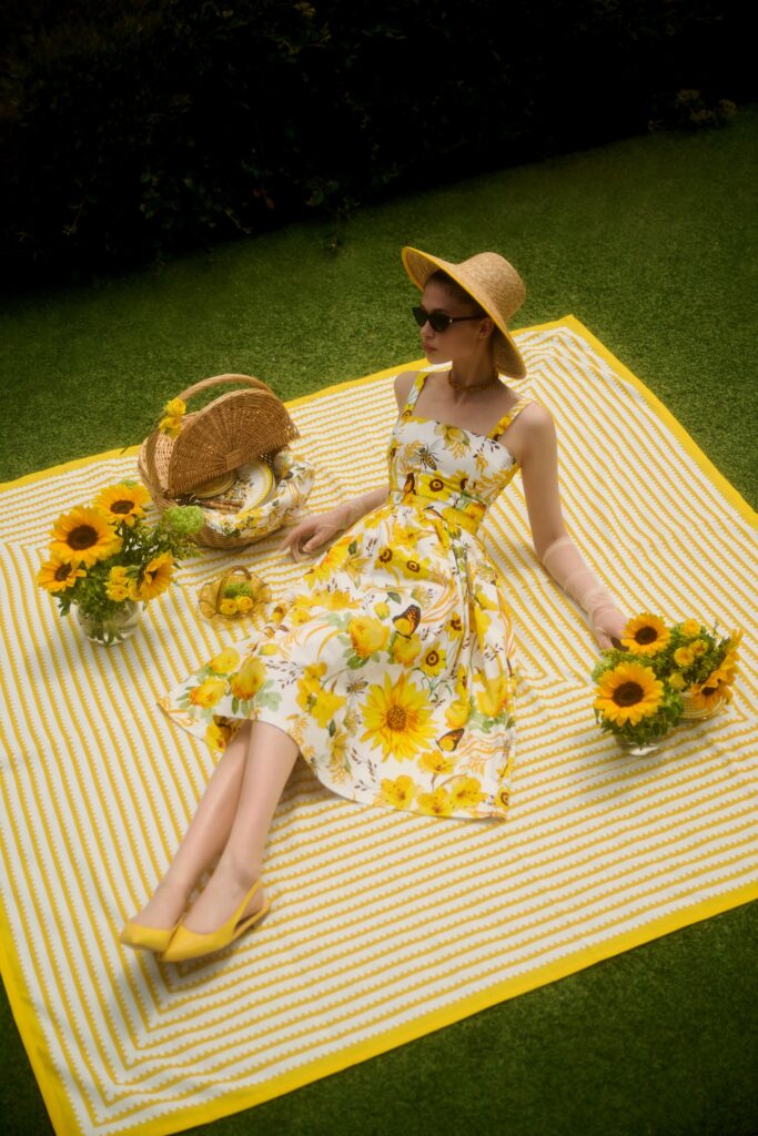 A fitted yellow floral sleeveless dress with a V-neckline, perfect for summer outings.
