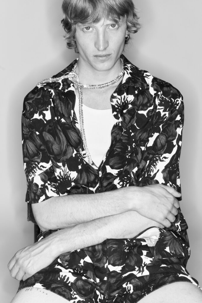 A relaxed black and white floral shirt with a V-neckline and short sleeves.