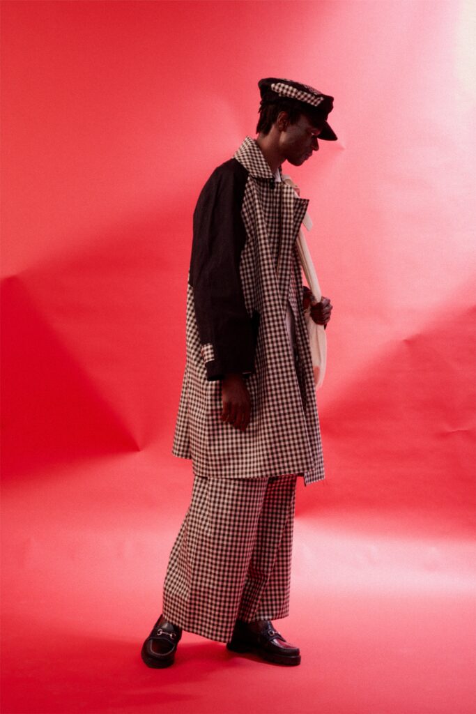 A relaxed black and white checked coat paired with matching pants, featuring a collared design.