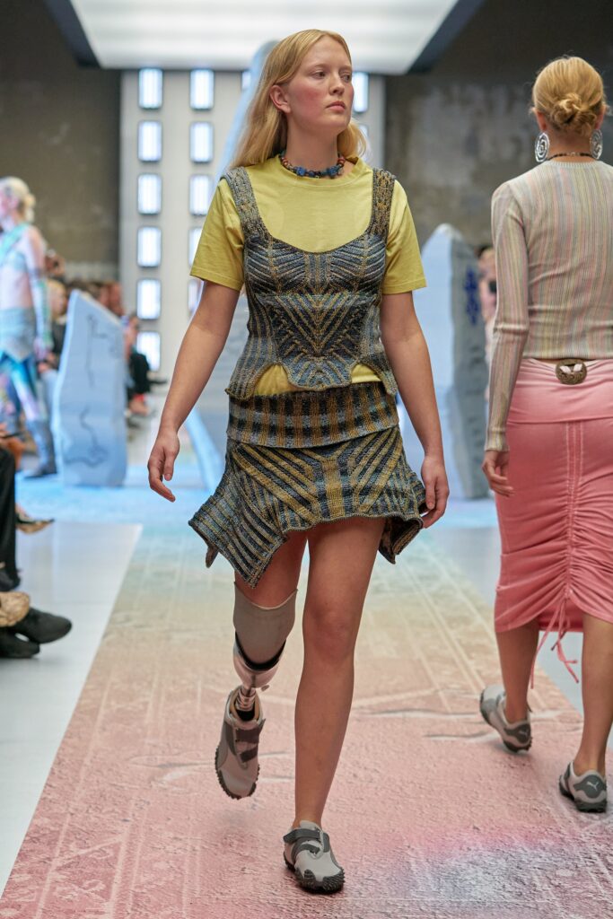 A fitted multicolor dress layered over a short-sleeve top, featuring a V-neckline.