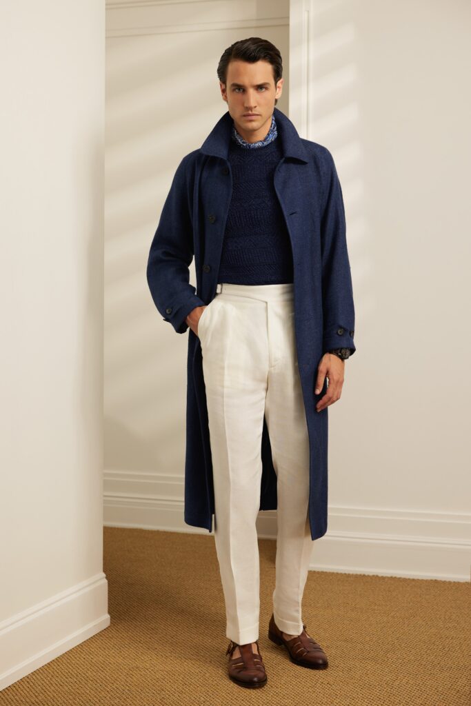 A tailored blue wool coat paired with white straight-leg pants for a sophisticated look.