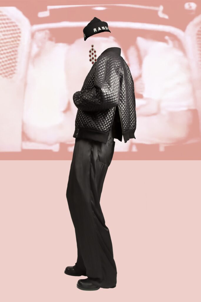 A relaxed black leather jacket with long sleeves paired with matching pants featuring a zippered detail.
