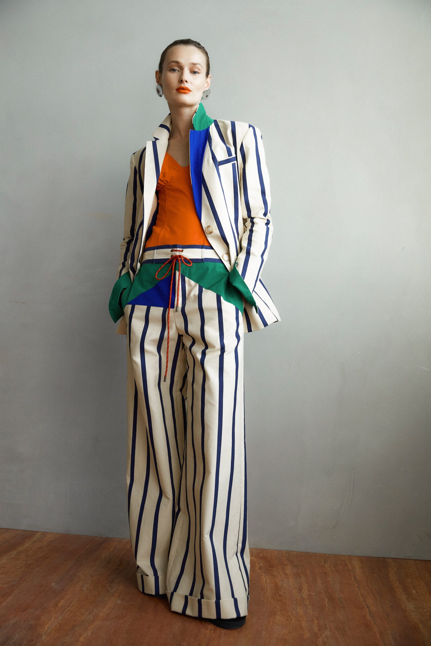 A relaxed fit striped suit featuring a collared long-sleeve jacket and vibrant colors.