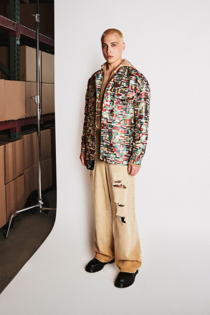 A relaxed-fit multicolor cotton jacket paired with beige distressed pants.