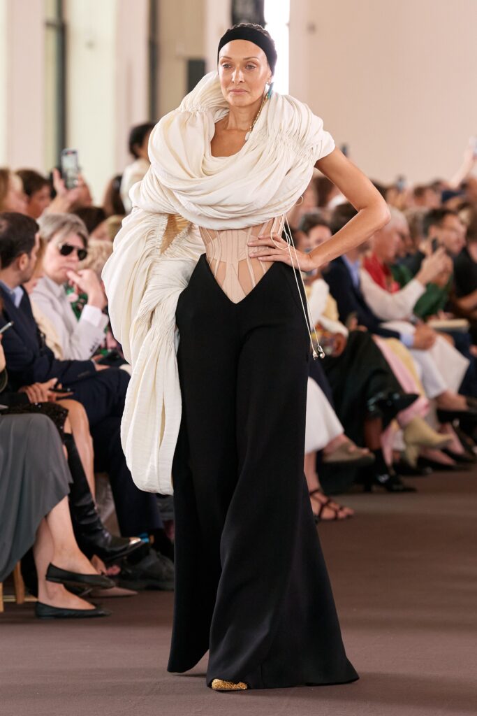 black pants beige corset white cape