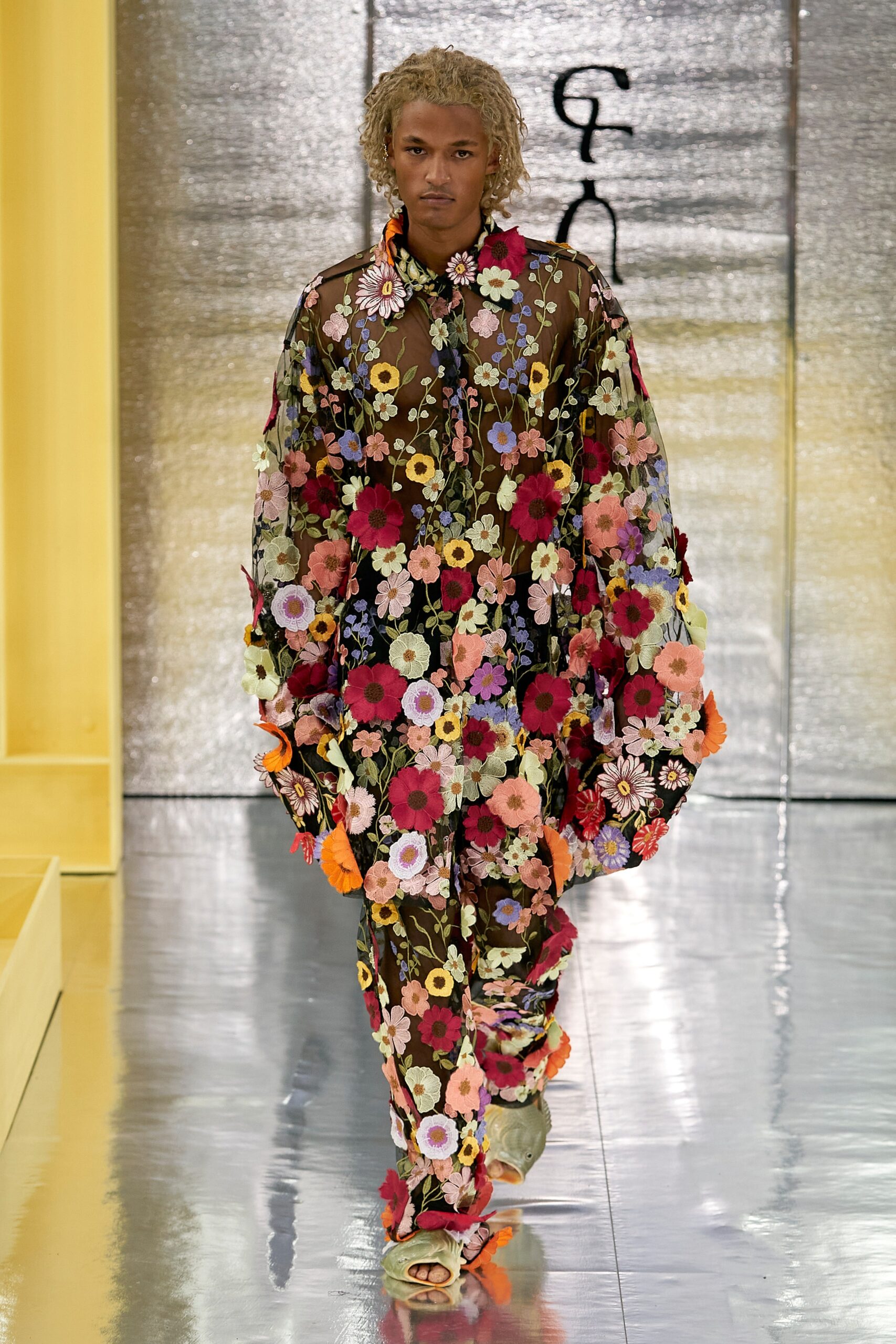 A relaxed multicolor sheer dress with long sleeves and flared pants, adorned with floral patterns.