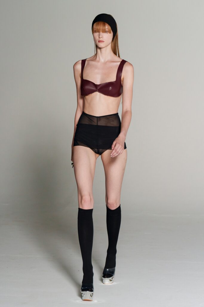 maroon vinyl bra with black shorts