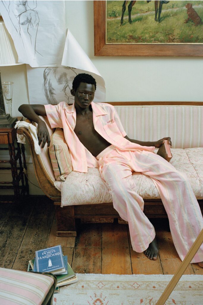 A relaxed pink striped shirt with short sleeves paired with matching relaxed pants.