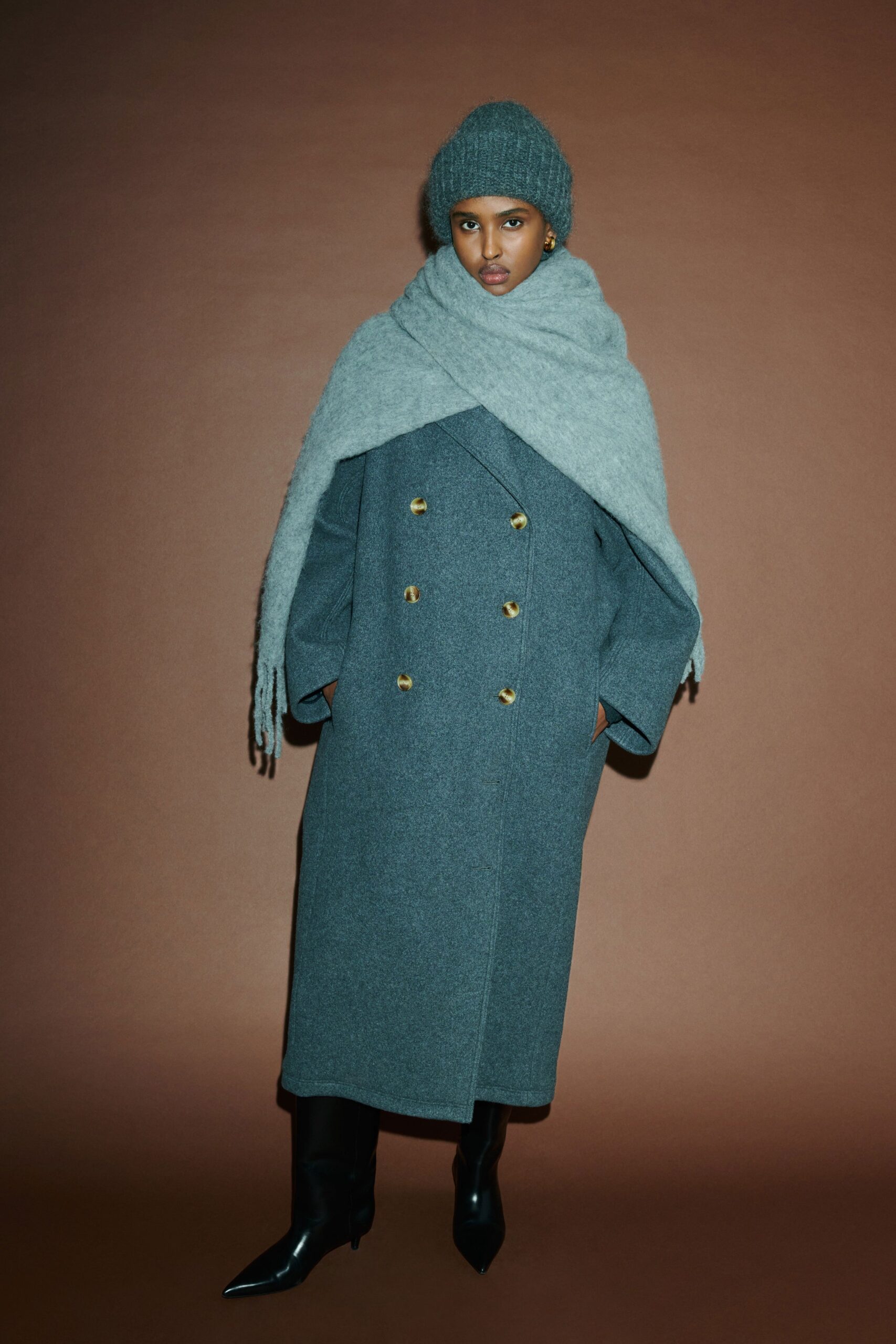 An oversized gray wool coat with long sleeves and a double-breasted design.