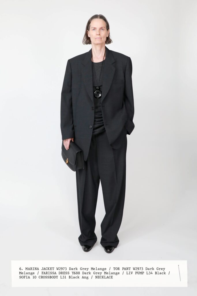 A relaxed black jacket with long sleeves and collared design paired with straight-leg pants.