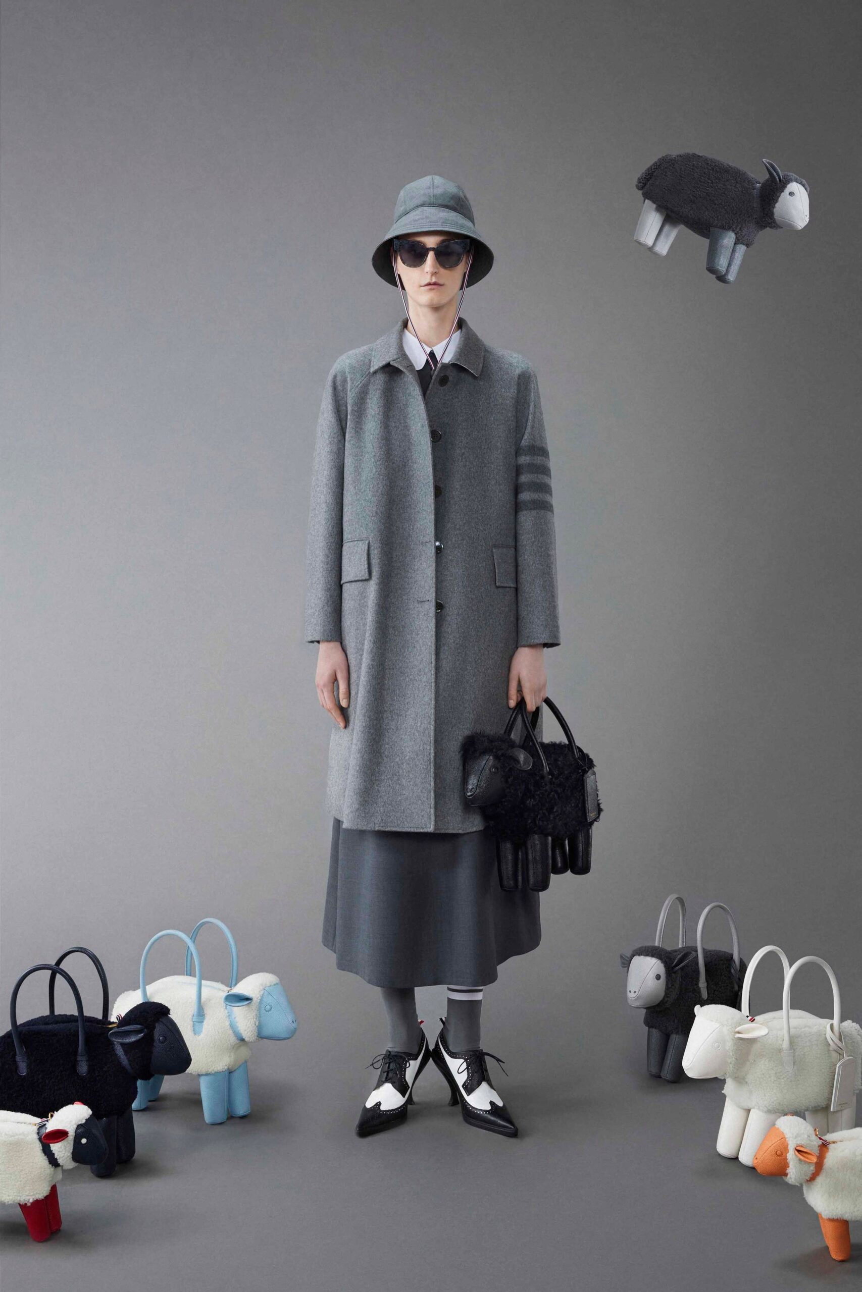 A relaxed gray wool coat with a collared long-sleeve design paired with a straight-leg skirt.