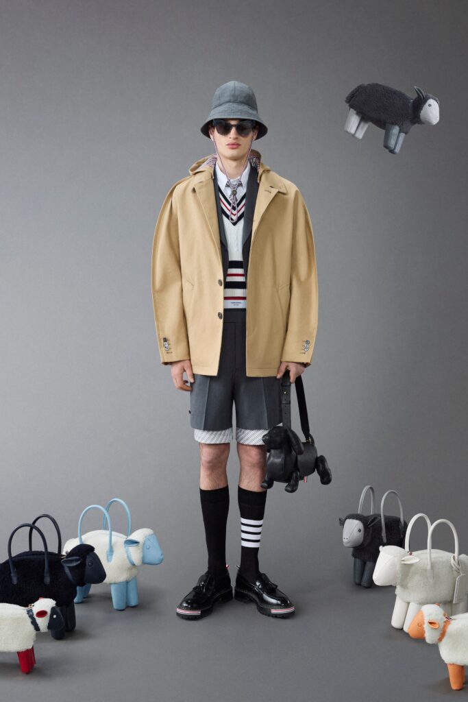 A relaxed beige jacket paired with gray shorts, featuring a collared design and striped details.